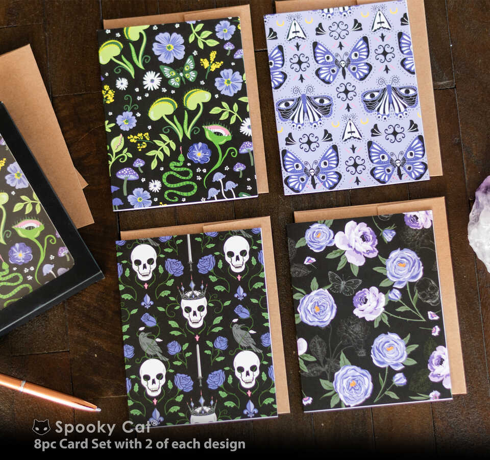 Set of four gothic floral greeting cards with skull, butterfly, mushroom, and dark botanical patterns displayed with envelopes.