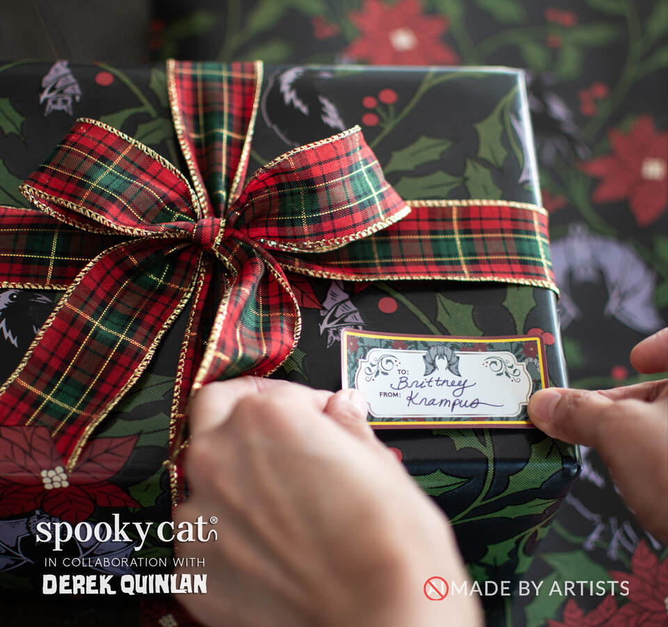 Gothic Victorian Christmas gift wrapped in Creepmas Yule Floral paper featuring ravens, bats, poinsettias and holly, with plaid ribbon and a vintage gift tag.