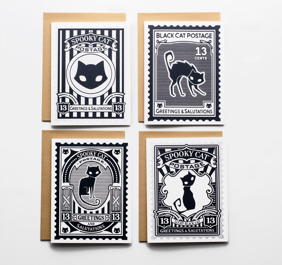 Four black and white cat-themed postage stamp designs on a white background.