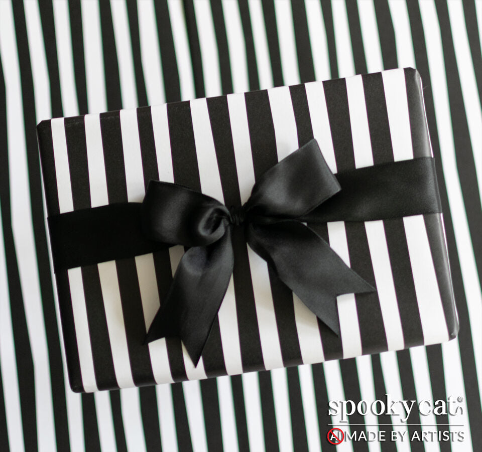Gift wrapped in Burton stripe paper featuring black and white irregular stripes tied with black ribbon.