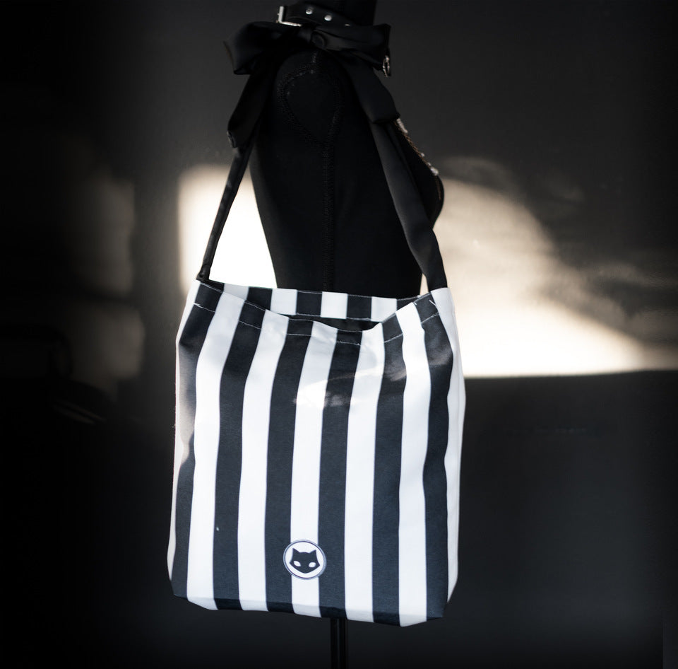 Statement canvas tote bag with bold stripes and bow strap for gothic fashion