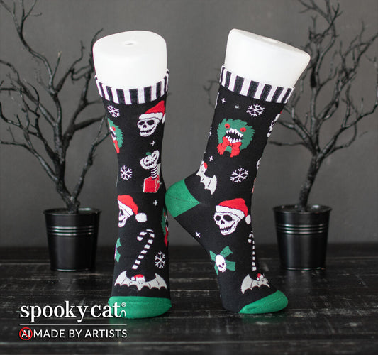 Spooky Cat Press Creepmas socks on white leg forms featuring skulls in Santa hats, monster wreaths, pumpkin jack-in-the-boxes, and green heels and toes.   