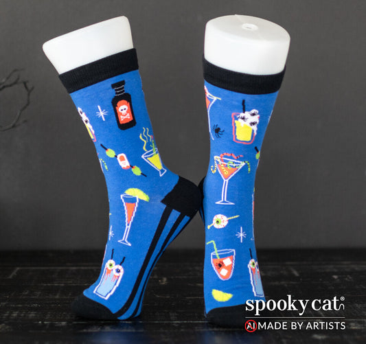 Blue socks with spooky cocktail drinks and eyeball garnishes worn on foot mannequin with Spooky Cat Logo
