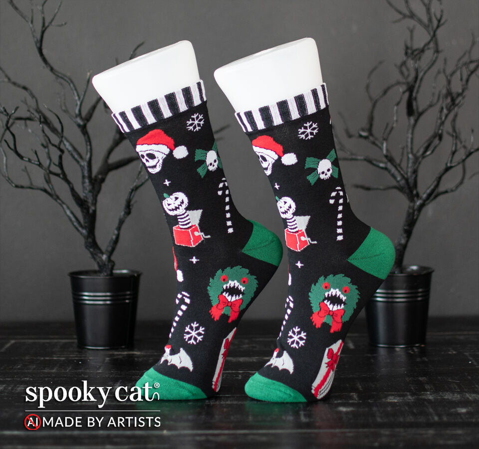 Side view of black Creepmas Gothmas crew socks on display, showcasing black and white striped cuffs with skull, bat, candy cane, and monster wreath patterns.