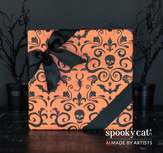 Gift wrapped in Orange Gothic Damask wrapping paper featuring  black skull and bat damask design on an orange background tied with black ribbon.
