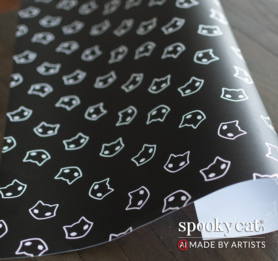 Flat view of gothic Halloween gift wrap showing a white Spooky Cat face logo on a matte black background.