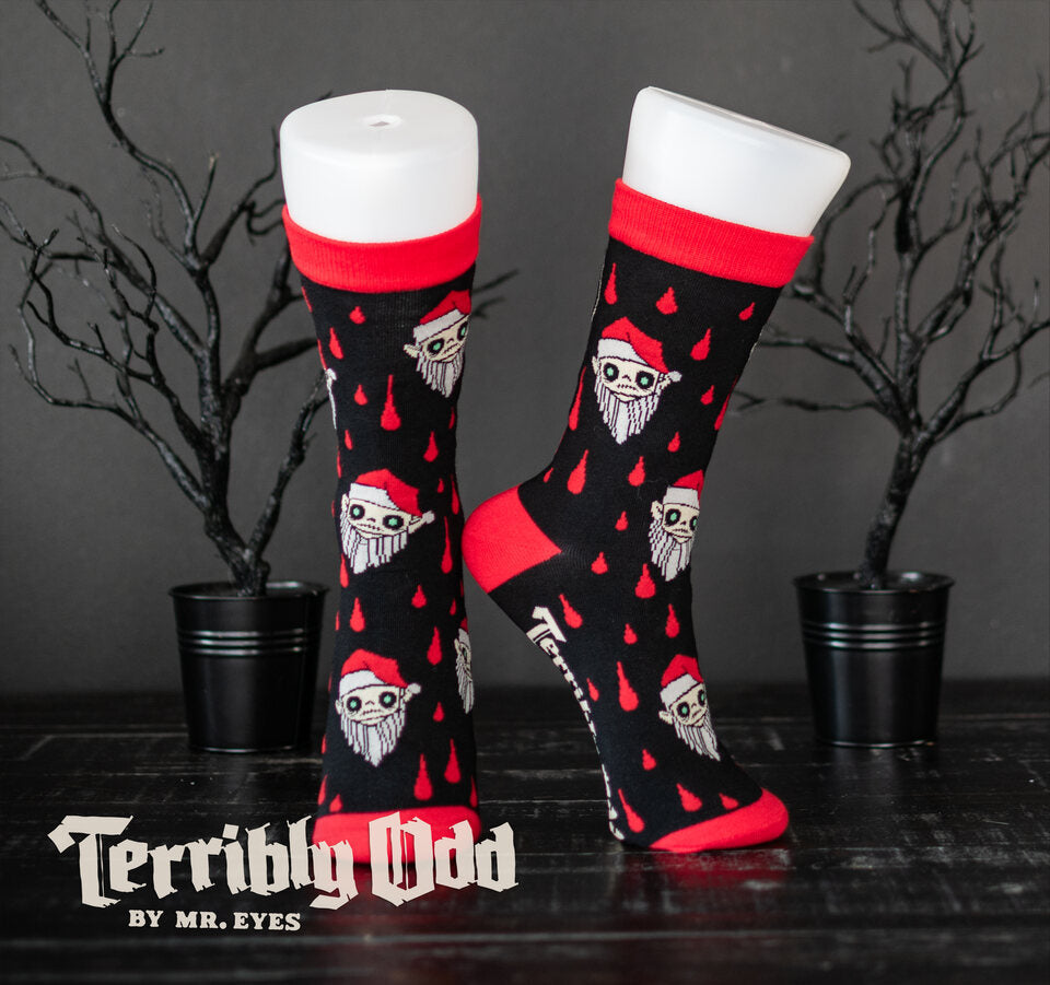 Spooky Cat Press x Terribly Odd collaboration socks on forms featuring the Little Orli vampire elf character, red blood drops, and black and red knit.