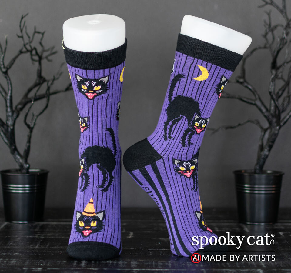 Vintage inspired purple Halloween socks with black cats, moons, and black stripes worn on a foot mannequin.