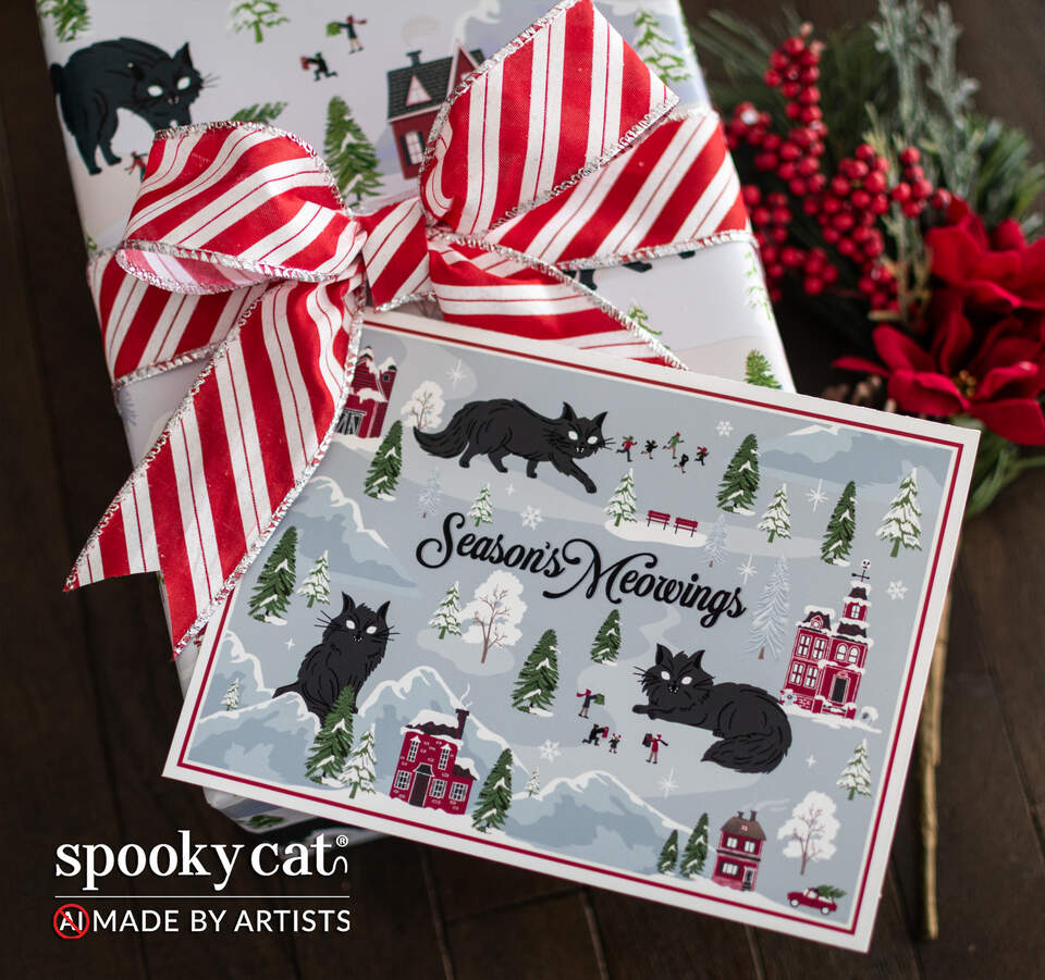 Creepmas greeting card reading “Season's Meowings” featuring Jólakötturinn, snowy Nordic villages, red houses and evergreen trees, displayed tucked into a gift wrapped in matching Yule cat gift wrap with a red and white striped bow. Text shows spooky cat logo. No AI. Made By Artists.