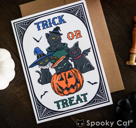 Black Cat Cute Halloween Card. Black kitties in a pumpkin and witch hat